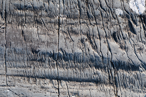 Old erosion marks in bedrock texture background