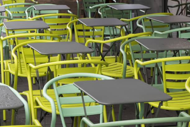 istock Colourful chairs and grey tables on a street terrace 1182830938