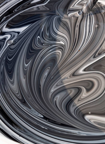 istock Photo white terrace paint in a jar with beautiful patterns when mixed with black pigment 1182832094