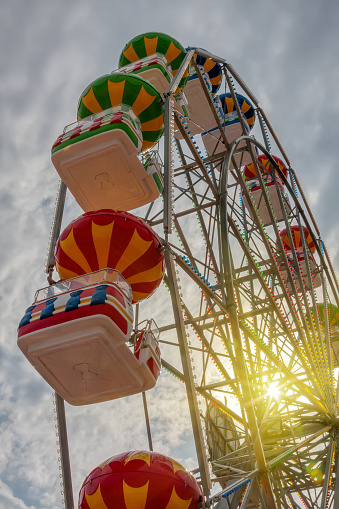 Ferris wheel at sunset against the sky in an amusement park