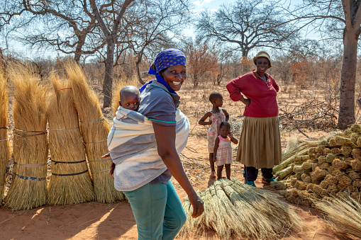 African women with their children walking in the bush in Botswana