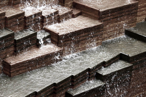 A fountain with many small water spouts shooting out of it. The water is white and the spouts are brown