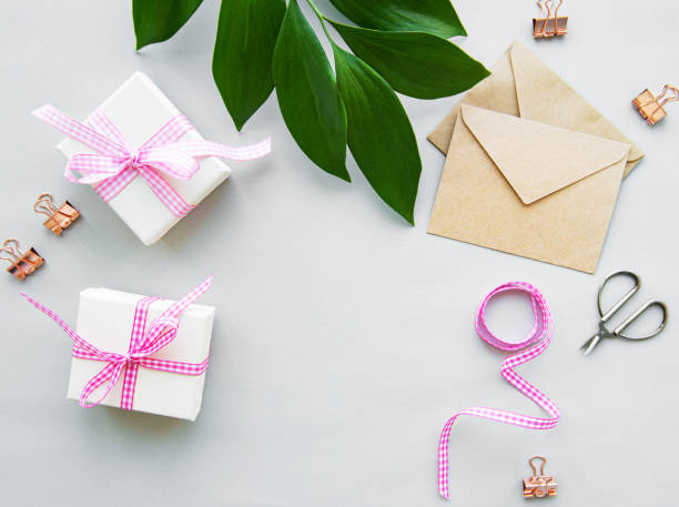 istock Gift boxes, envelope and with green leaves on a white background 1182834965