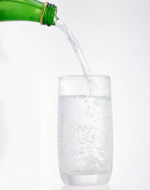 istock cold water is poured into a drinking glass,isolated on a white background 1182836970