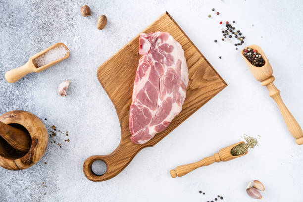 viande de porc crue fraîche avec grains de poivre, assaisonnements et épices, prêt à griller. vue du haut - porc viande photos et images de collection