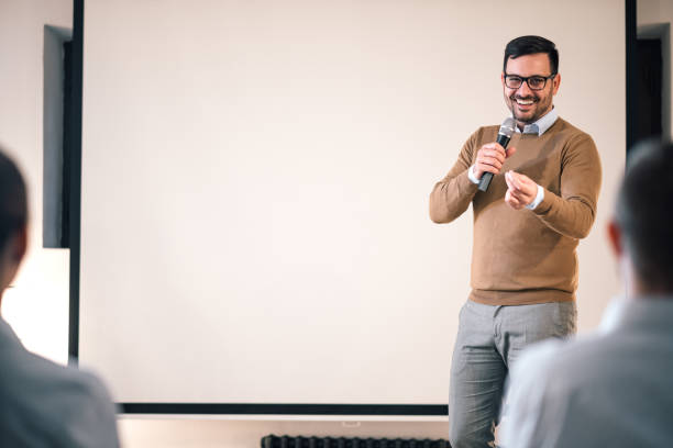 istock Business man giving presentation in a conference setting, copy space. 1182838367