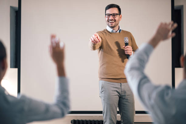 istock Hands in audience raised for a question at a seminar. 1182838370