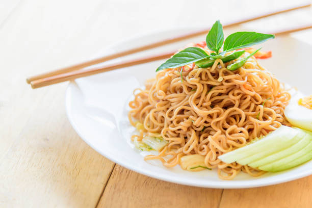 istock fried noodles with chilli on wood table 1182840282