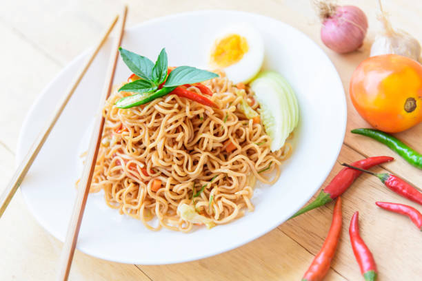 istock fried noodles with chilli on wood table 1182840284