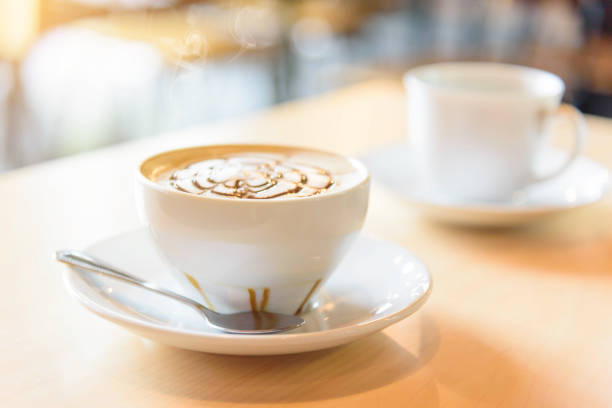 istock hot coffee on table / hot cappuccino with nice pattern milk foam 1182840314