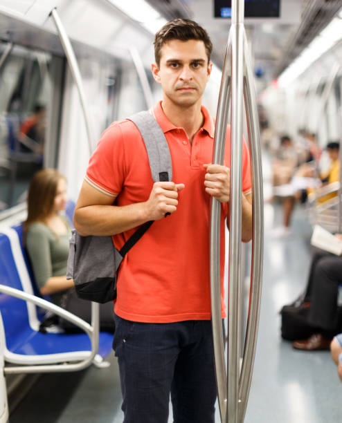 istock Man is standing in train and looking in the phone 1182840728