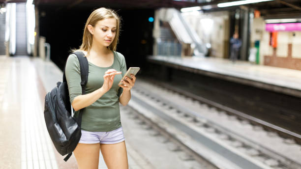 istock Woman is standing on platform and waiting train 1182840733