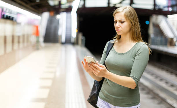 istock Woman is looking on railway and waiting train on platform 1182840739
