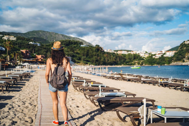 istock Woman walking on beach 1182841441