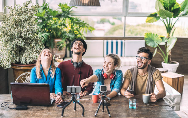 istock Young millenial friends sharing creative content online - Digital marketing concept with next generation influencer having fun on air with radio video stream - Vlogging time at startup coworking space 1182843190
