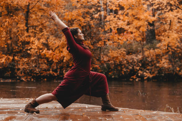 istock Plus size girl doing yoga in nature. 1182843219