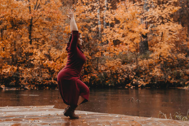 istock Plus size girl doing yoga in nature. 1182843234