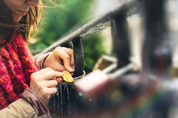 woman locking love padlock on bridge - passion women human hand macro imagens e fotografias de stock