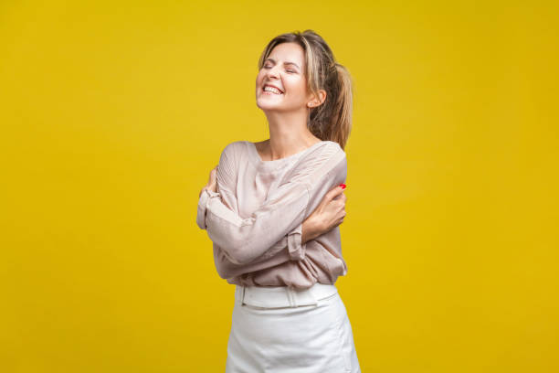 i love myself. portrait of proud beautiful woman with fair hair in casual beige blouse, isolated on yellow background - urgency body care young adult people imagens e fotografias de stock