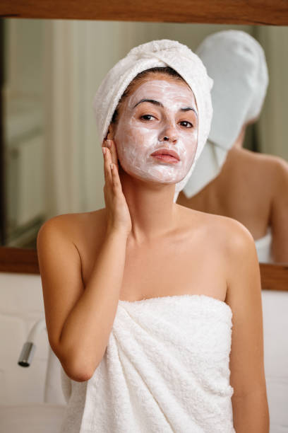 istock Woman is applying mask on her face 1182843764