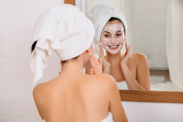 istock Woman is applying mask on her face 1182843857