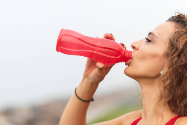 istock woman drinks water at training 1182843903