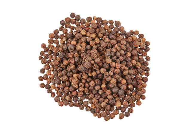istock Black peppercorns isolated on white background with copy space for text or images. Spices and herbs. Packaging concept. Close-up, top view 1182844019