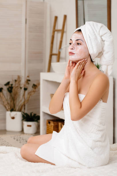 istock Woman is applying mask on her face 1182844651