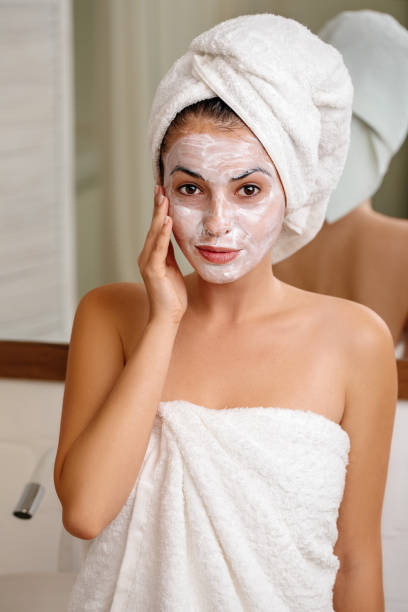 istock Woman is applying mask on her face 1182844673