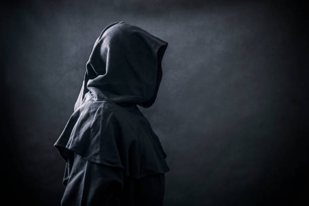 istock Scary figure in hooded cloak 1182847014