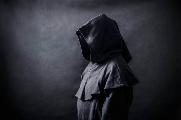 istock Scary figure in hooded cloak 1182847360