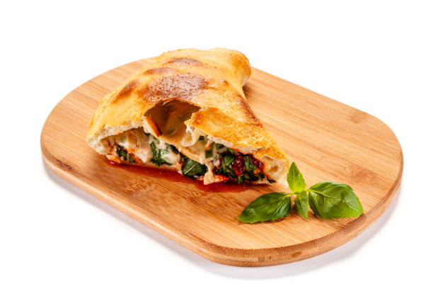istock Calzone Pizza on cutting board on white background 1182847475