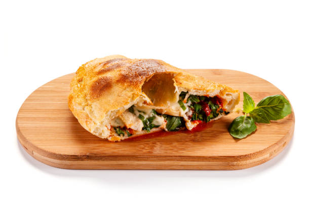 istock Calzone Pizza on cutting board on white background 1182848043
