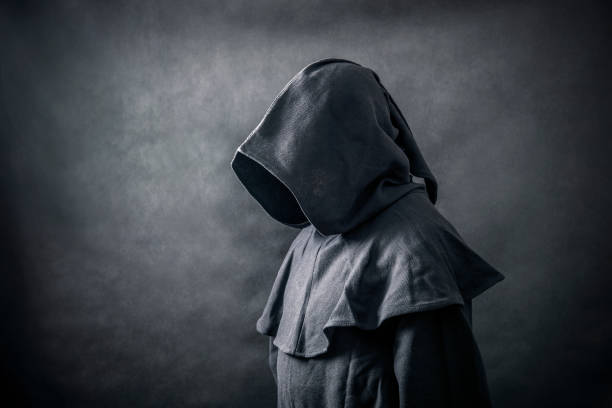 Scary figure in hooded cloak Scary figure in hooded cloak ceremonial robe stock pictures, royalty-free photos & images