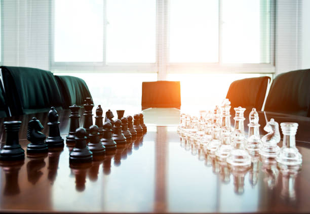 istock Chess pieces and board on the conference table 1182848313