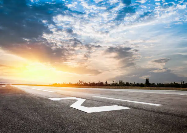 Photo of Empty airport runway at sunset
