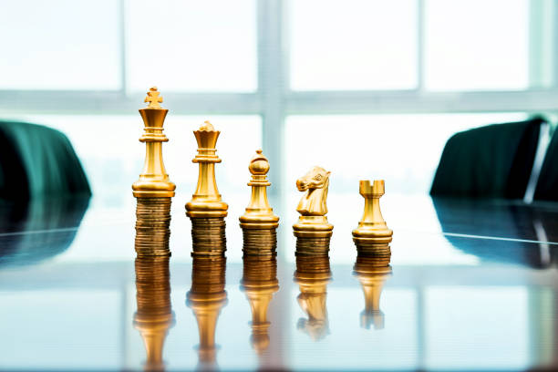istock Chess pieces standing on the stacked coins 1182848694