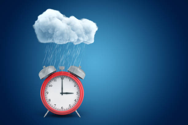 istock 3d rendering of red alarm clock standing under cloud of pouring rain on blue copyspace background. 1182849144