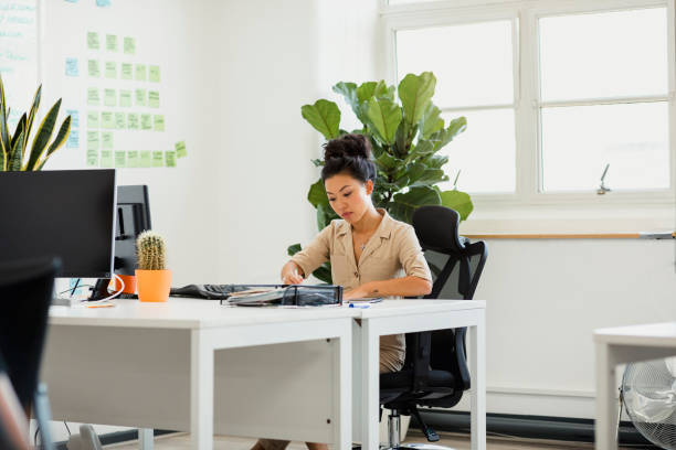 istock Woman Filling out Paperwork 1182849407