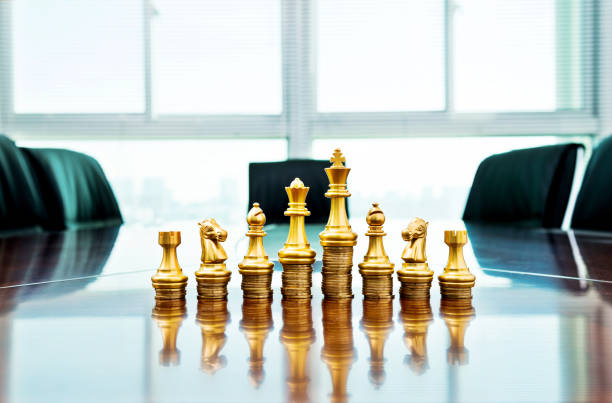istock Chess pieces standing on the stacked coins 1182850513