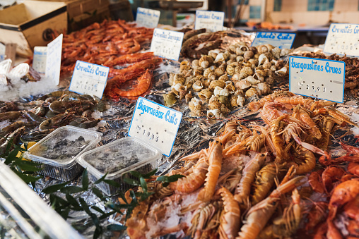 Shot of freshly caught lobsters, periwinkle and other sea food delicacies at a fish market in Paris, France