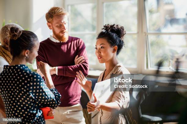 Discussing Business With Colleagues Stock Photo - Download Image Now - Teamwork, Business, Working