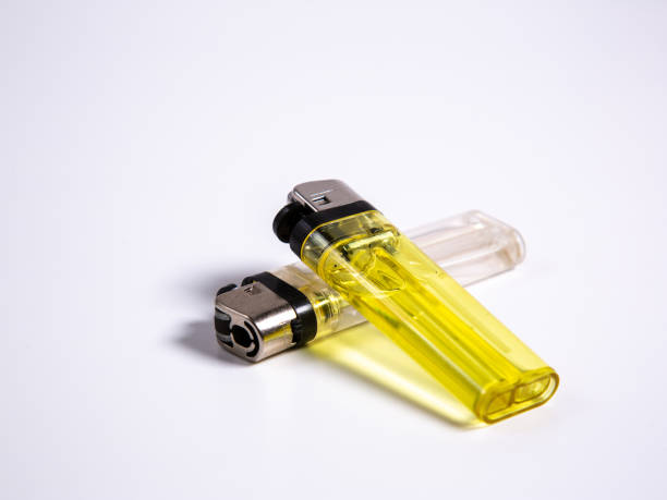 istock two gas lighters in yellow and white on a white background 1182850682