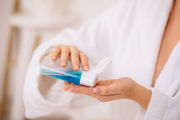 istock women's hands hold tonic to remove makeup. 1182850902