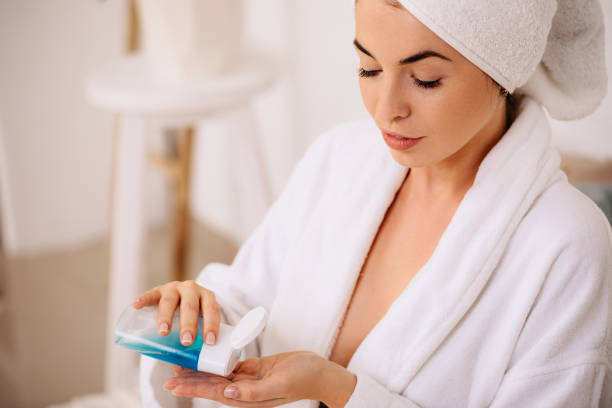 istock woman uses tonic or lotion product. 1182850912
