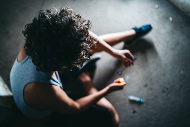 Female addict preparing heroin dose Young caucasian female addict preparing heroin dose. morphine drug stock pictures, royalty-free photos & images