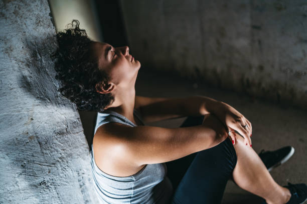 istock Depressed helpless woman sitting alone 1182851188