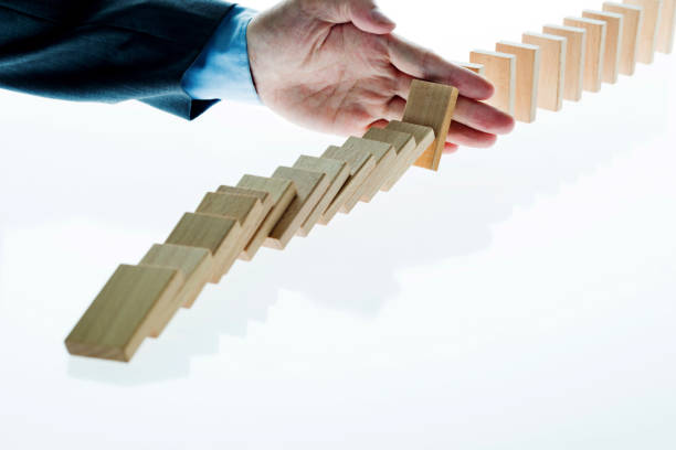 istock Businessman hand stop domino effect 1182851832