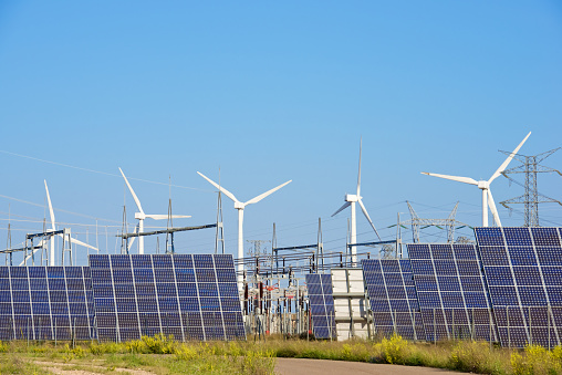 Windmills and photovoltaic panels for energy production, Navarra, Spain.