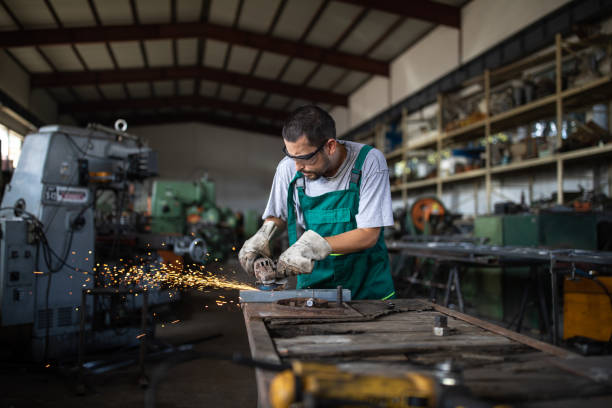 istock Working with angle grinder in metal industry 1182856276